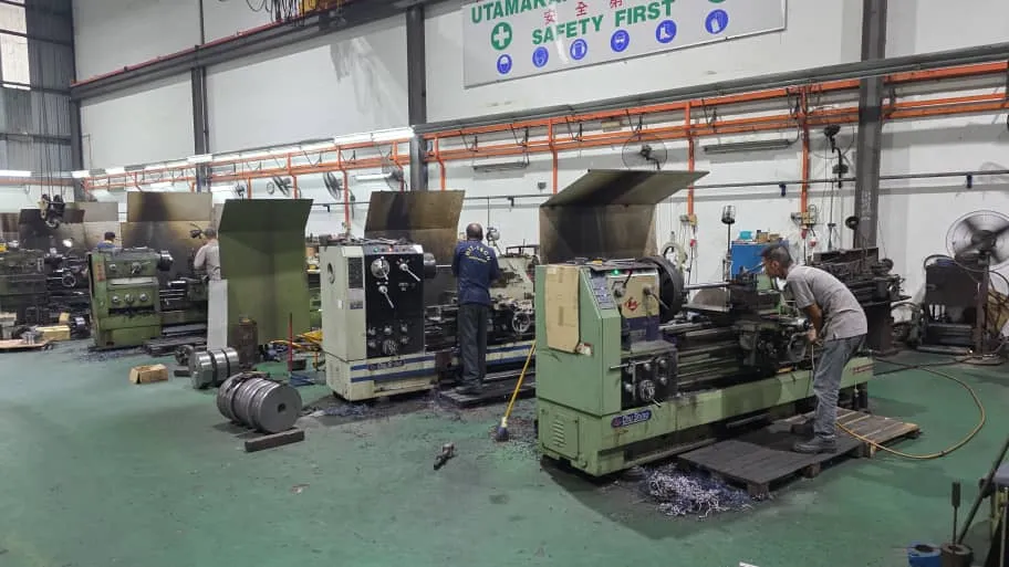 Workshop floor with a row of lathes being operated by machinists